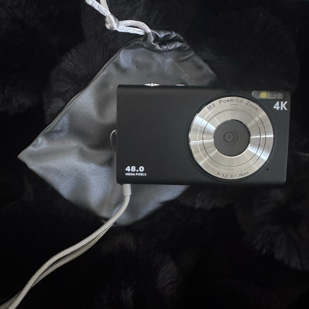 Black 4K Digital Camera with Silver Accents